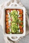 Vegan Fajita Enchiladas! These enchiladas are perfect for Cinco de Mayo. Roasted peppers, onions and beans covered in a homemade enchilada sauce and avocado. | www.delishknowledge.com
