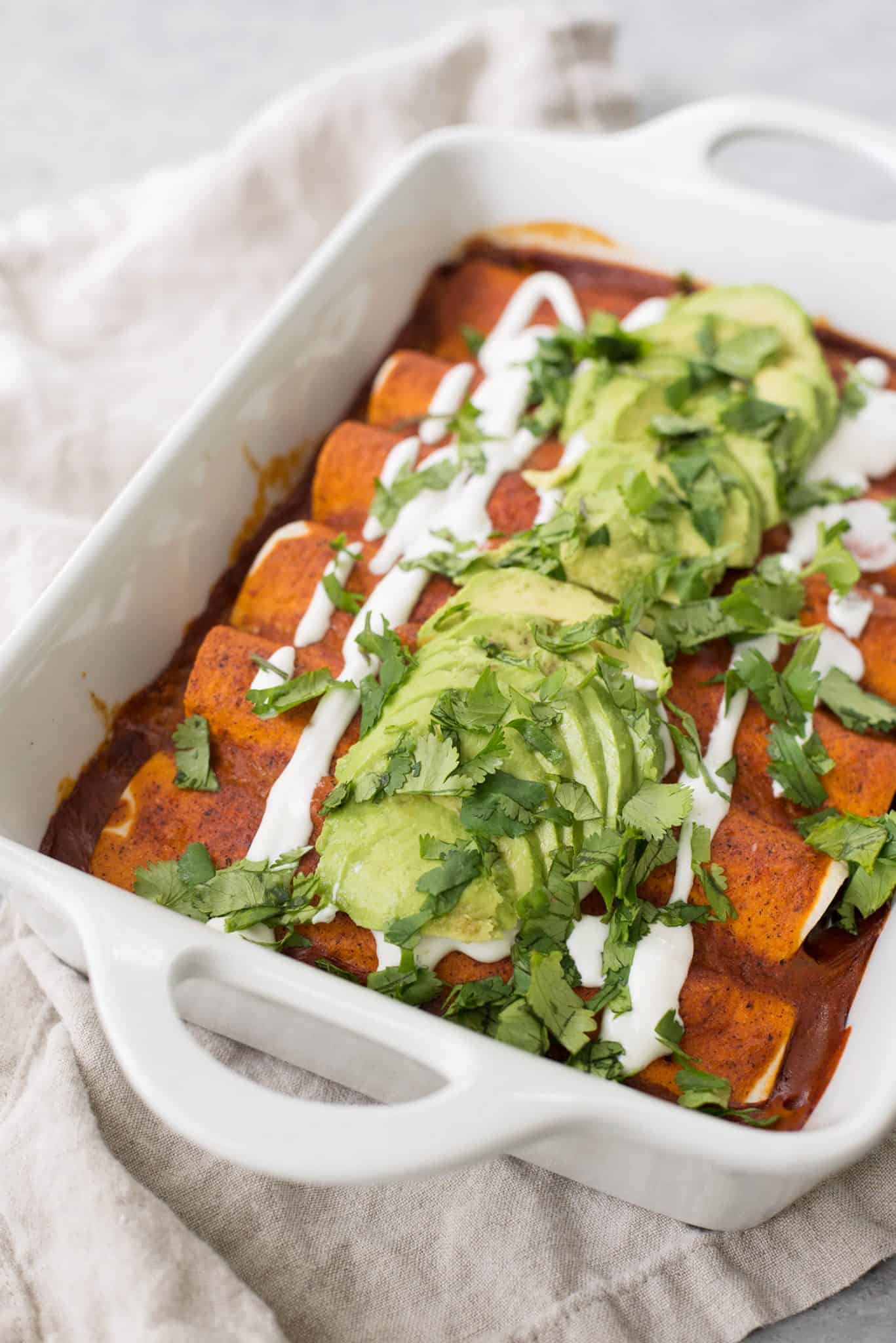 Vegan Fajita Enchiladas! These Enchiladas Are Perfect For Cinco De Mayo. Roasted Peppers, Onions And Beans Covered In A Homemade Enchilada Sauce And Avocado. | Www.delishknowledge.com