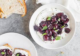 whipped ricotta with cherries on a plate