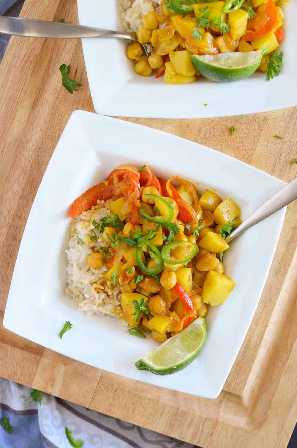 Yellow Curry Bowls! These vegan and gluten free curry bowls are a MUST-MAKE! Potatoes, chickpeas & peppers simmered in a coconut curry sauce. | www.delishknowledge.com