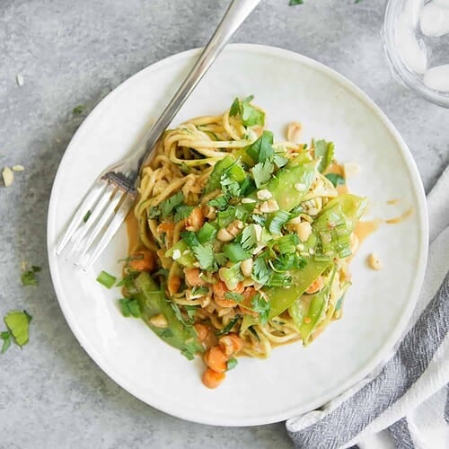 Zoodle Stir Fry With Spicy Peanut Sauce! You'Ve Gotta Try This One-Skillet Meal, Vegan And Gluten-Free. Spiralized Zucchini, Snow Peas, Carrots And Herbs In A Spicy Peanut Sauce. Enjoy As Is Or Add Your Favorite Protein. | Www.delishknowledge.com