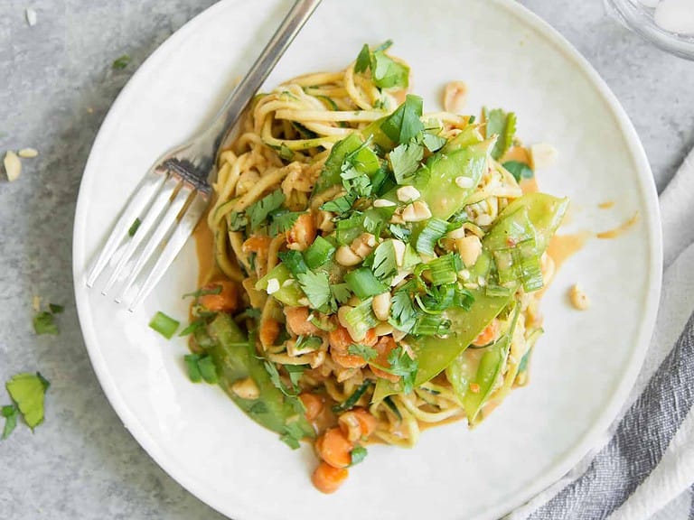 Zoodle Stir Fry With Spicy Peanut Sauce! You'Ve Gotta Try This One-Skillet Meal, Vegan And Gluten-Free. Spiralized Zucchini, Snow Peas, Carrots And Herbs In A Spicy Peanut Sauce. Enjoy As Is Or Add Your Favorite Protein. | Www.delishknowledge.com