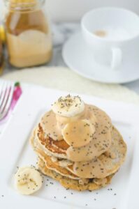 Vegan chia pancakes topped with velvety, decadent maple-peanut butter syrup and fresh sliced bananas!