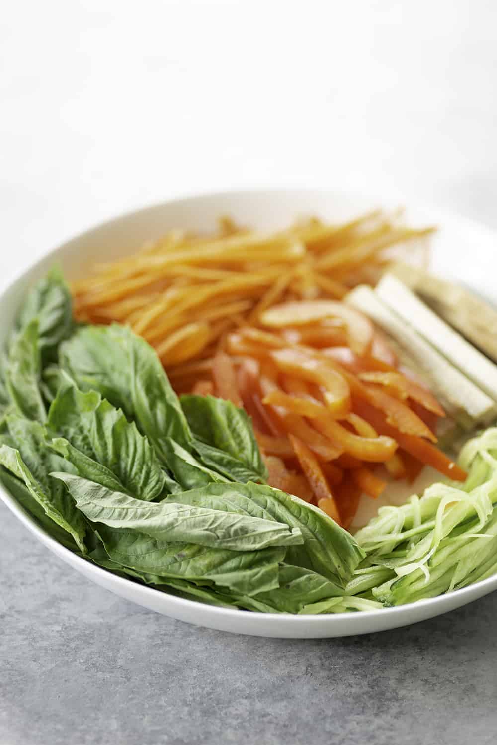 Bowl Of Basil And Vegetables For The Summer Rolls