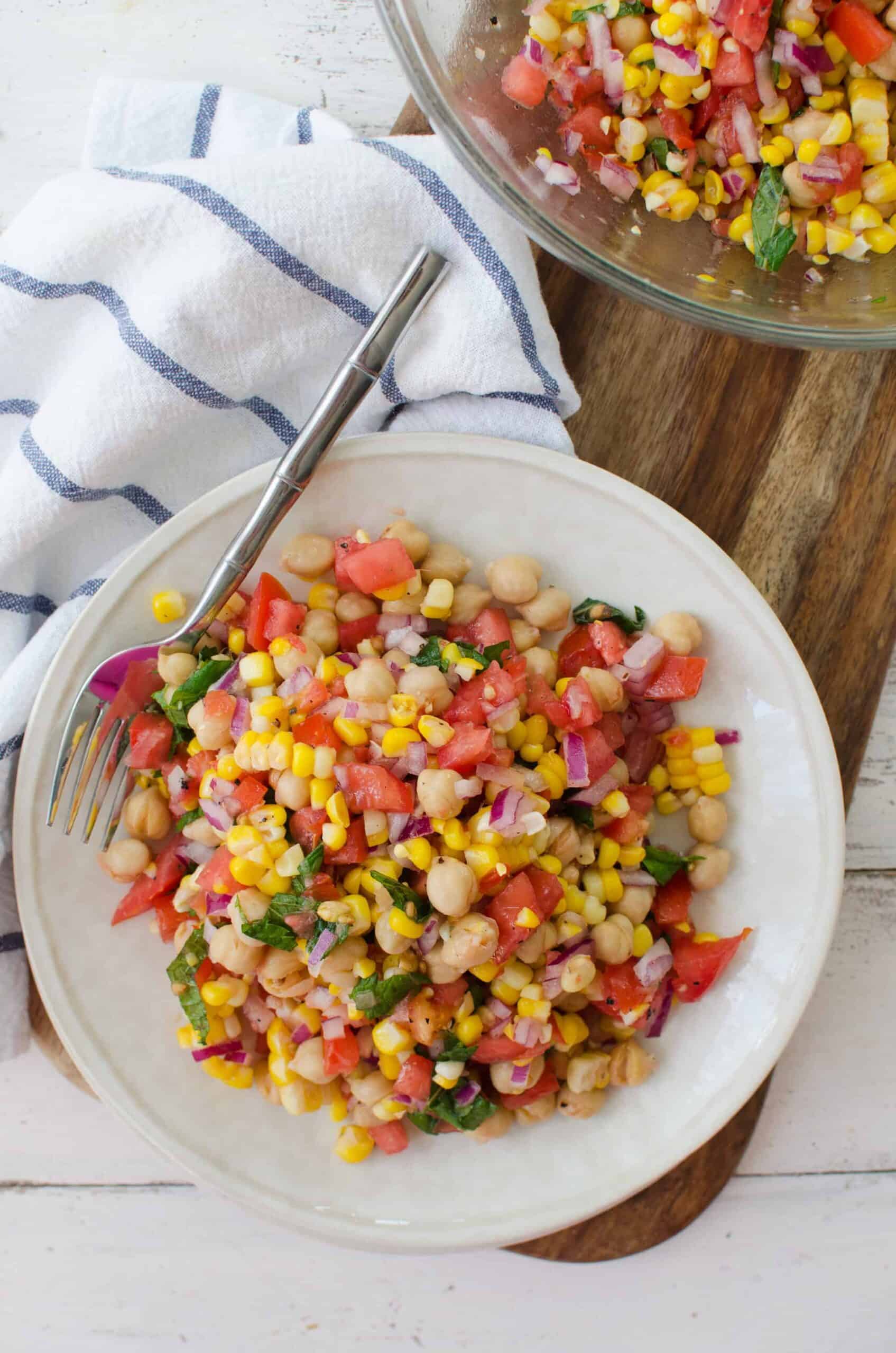 Corn, Tomato And Mint Salad! This Gluten-Free, Vegan Side Dish Is Perfect For Summer! Juicy Tomatoes, Fresh Corn, Onion, Chickpeas And A Lemon Mint Dressing. High-Fiber And Full Of Protein! | Www.delishknowledge.com