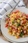 Corn, Tomato and Mint Salad! This gluten-free, vegan side dish is perfect for summer! Juicy tomatoes, fresh corn, onion, chickpeas and a lemon mint dressing. High-fiber and full of protein! | www.delishknowledge.com