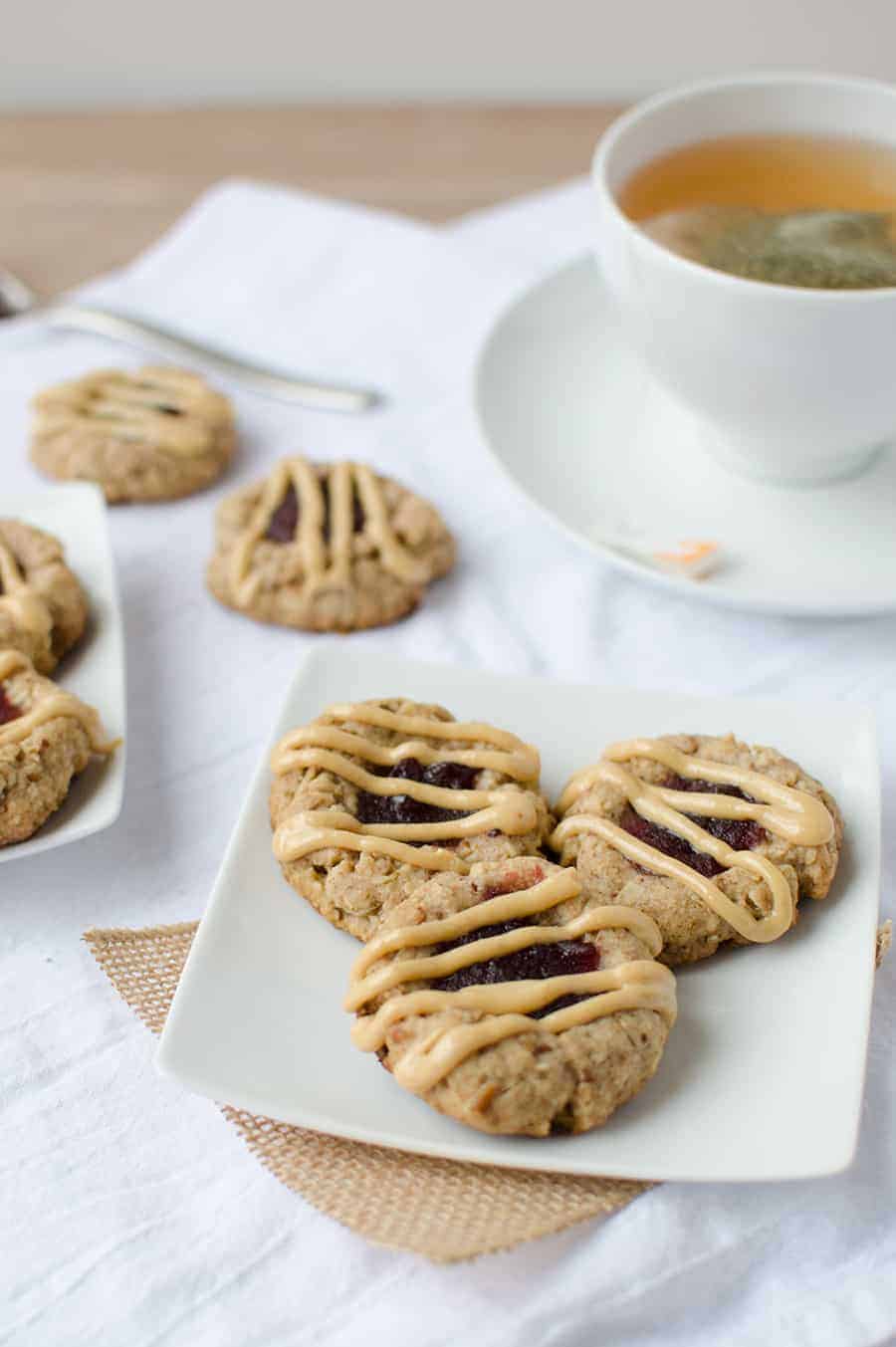 Thumbprint Cookies! Pecan Cookies Topped With Cranberry Jam And Peanut Butter Drizzle. Wholesome, Naturally Sweetened And Vegan! | Www.delishknowledge.com