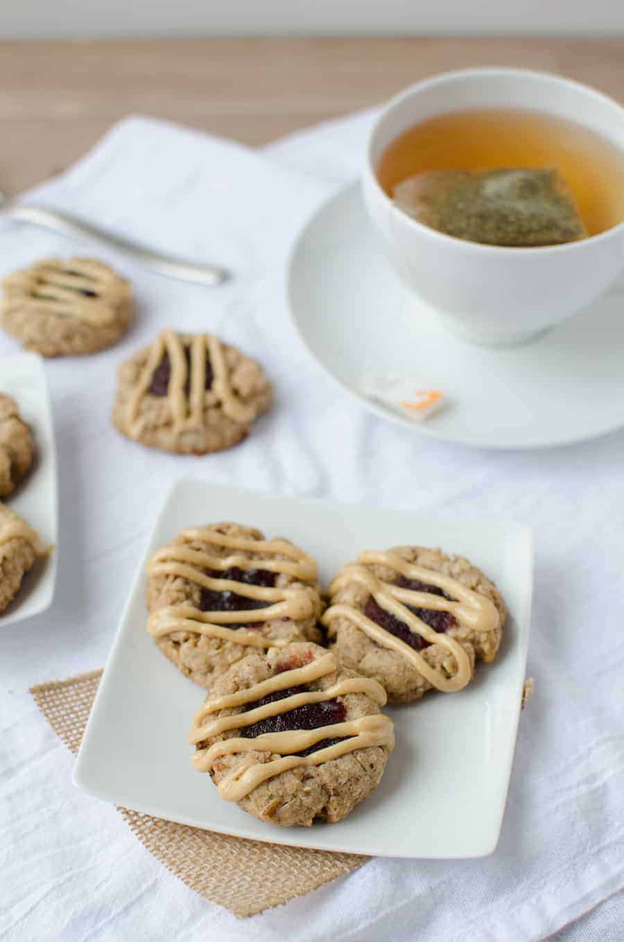 Thumbprint Cookies! Pecan Cookies Topped With Cranberry Jam And Peanut Butter Drizzle. Wholesome, Naturally Sweetened And Vegan! | Www.delishknowledge.com