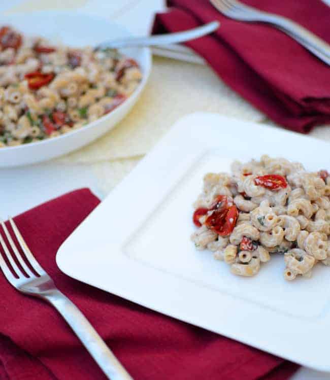 A serving of the cauliflower sauce pasta on a plate with a fork