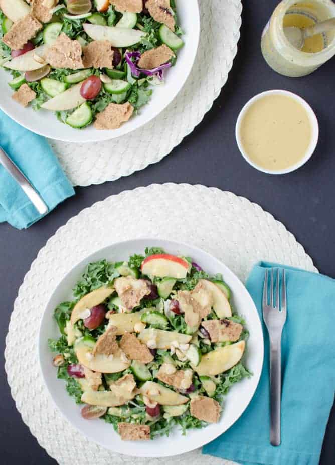 Fall Fattoush Salad! Kale salad tossed with sliced apples, juicy grapes, maple-mustard dressing and topped with pita chips. Vegan and Gluten Free.