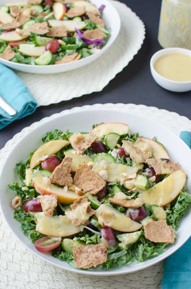 Fall Fattoush Salad! Kale salad tossed with sliced apples, juicy grapes, maple-mustard dressing and topped with pita chips. Vegan and Gluten Free.