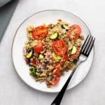 greek lentil salad in plate with fork