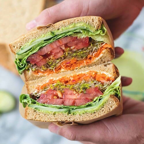 Green Goddess Veggie Sandwich! This Sandwich Is Layered With Flavor And Packed With Vegetables! Homemade Green-Goddess Dressing, Tomatoes, Sprouts, Avocado, Goat Cheese, Radish, Carrots. Vegetarian, Easily Vegan Or Gluten-Free. | Www.delishknowledge.com
