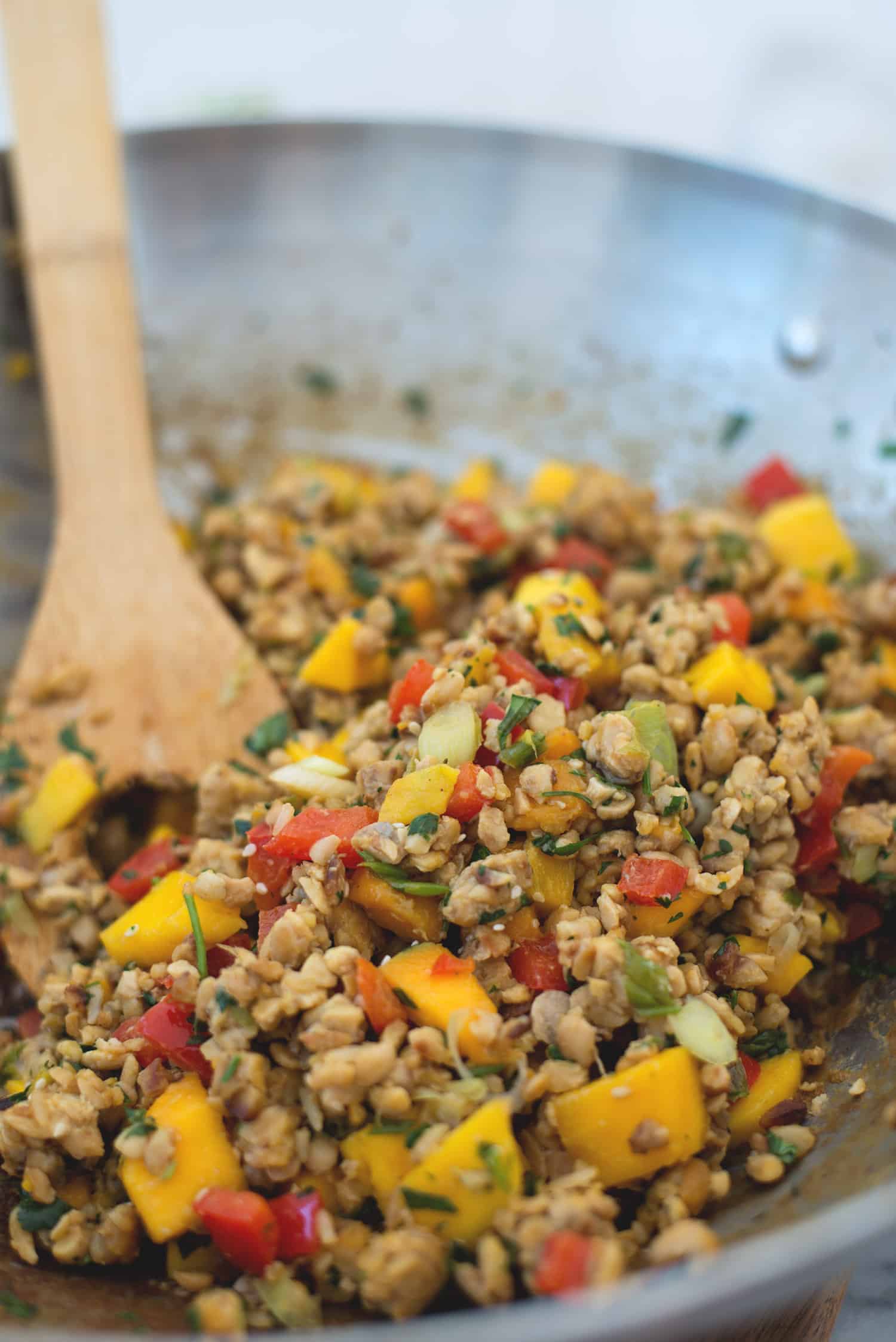Tempeh Mango Lettuce Wraps! Spicy ground tempeh with peppers and mango, stuffed into butter lettuce cups. Vegan & Gluten-Free | www.delishknowledge.com