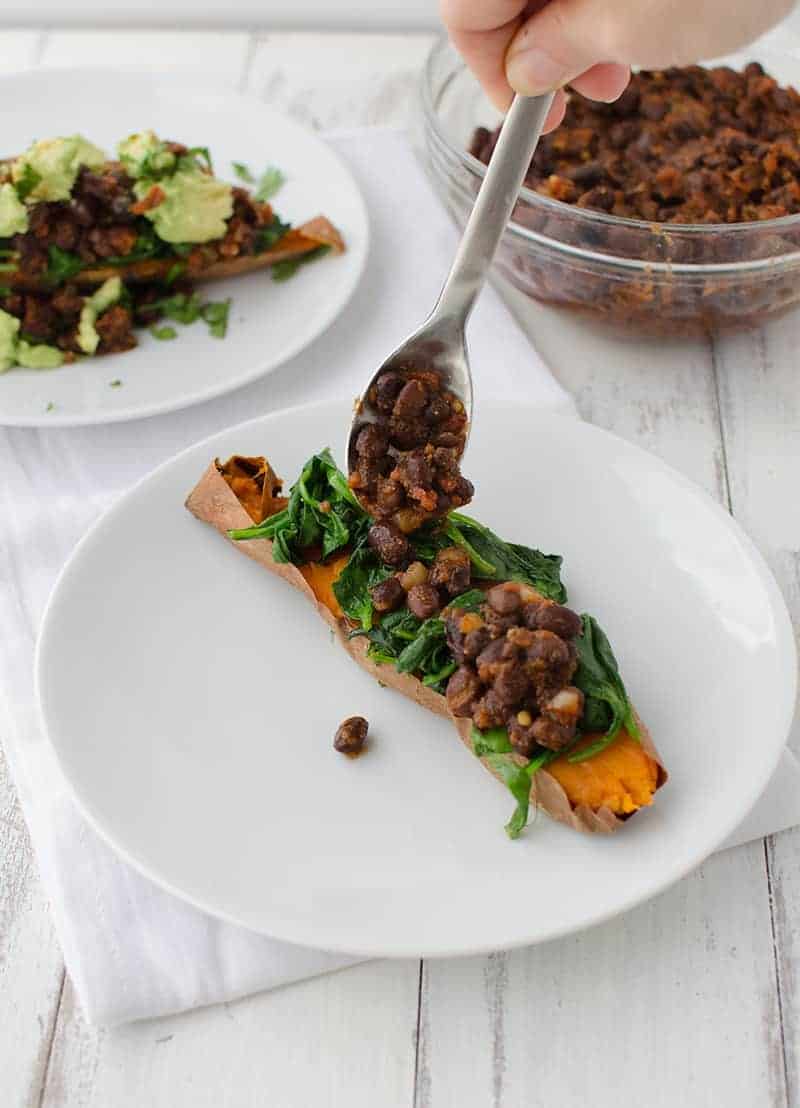 Mexican Stuffed Sweet Potatoes! Baked Potatoes Stuffed With Spinach, Spicy Black Beans, Avocado And Cilantro. This Meal Is So Filling And Packed With Nutrition! Gluten Free And Vegan! | Www.delishknowledge.com