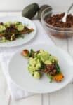 Mexican Stuffed Sweet Potatoes! Baked potatoes stuffed with spinach, spicy black beans, avocado and cilantro. This meal is so filling and packed with nutrition! Gluten free and vegan! | www.delishknowledge.com