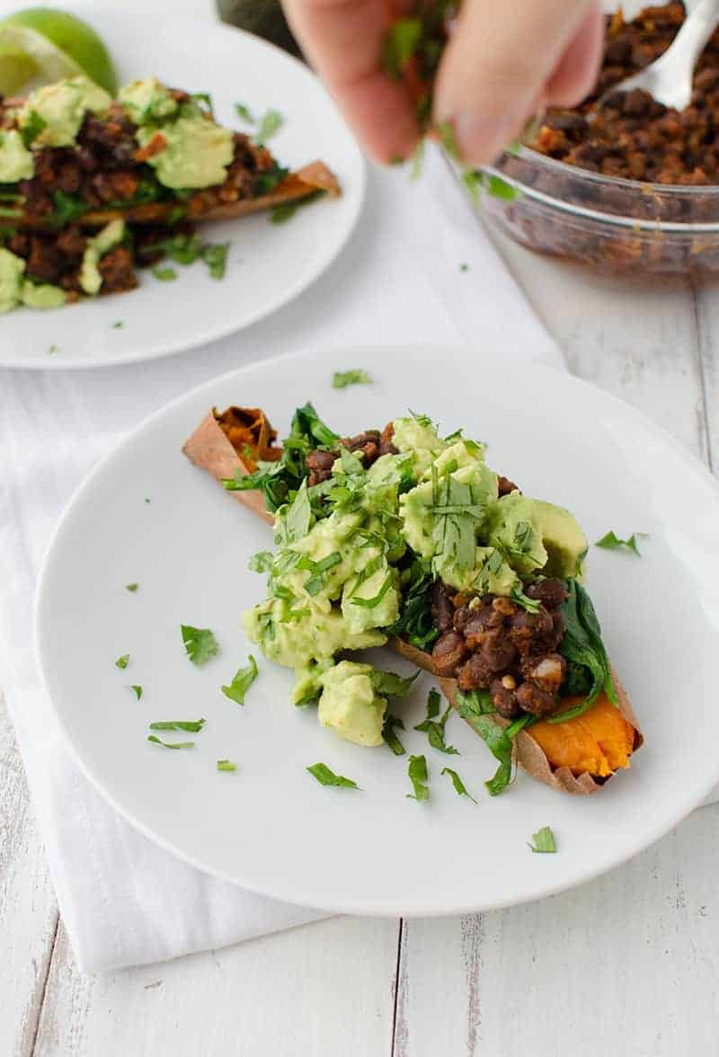 Mexican Stuffed Sweet Potatoes! Baked Potatoes Stuffed With Spinach, Spicy Black Beans, Avocado And Cilantro. This Meal Is So Filling And Packed With Nutrition! Gluten Free And Vegan! | Www.delishknowledge.com