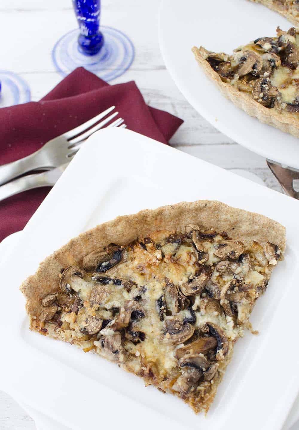 Caramelized onion and mushroom tart! The perfect vegetarian appetizer, side or main dish. Whole wheat tart stuffed with onions, mushrooms, and gorgonzola cheese. | www.delishknowledge.com