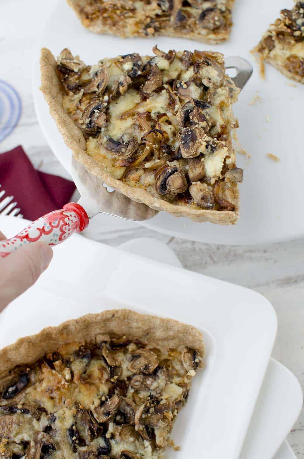 Caramelized onion and mushroom tart! The perfect vegetarian appetizer, side or main dish. Whole wheat tart stuffed with onions, mushrooms, and gorgonzola cheese. | www.delishknowledge.com