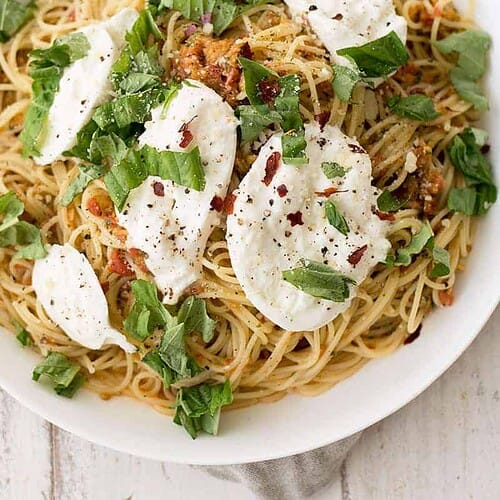 Pasta Checca With Burrata! This Recipe Is Ready In Less Than 20 Minutes. Quick, No-Cook Sauce Tossed With Hot Angelhair Pasta And Topped With Creamy Burrata. Vegetarian. | Www.delishknowledge.com