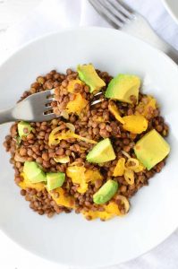 Who says lentils are boring!? Not these! A twist on traditional lentil salad! French lentils cooked in orange juice then topped with oranges, shallots and creamy avocado. #vegan and #lglutenfree | www.delishknowledge.com