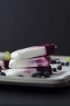 Roasted Blueberry, Coconut and Lime Popsicles! Roasting intensifies the sweetness of the berries, with very little added sugar. Layers of roasted blueberries, coconut and lime. Vegan & Gluten-Free | www.delishknowledge.com