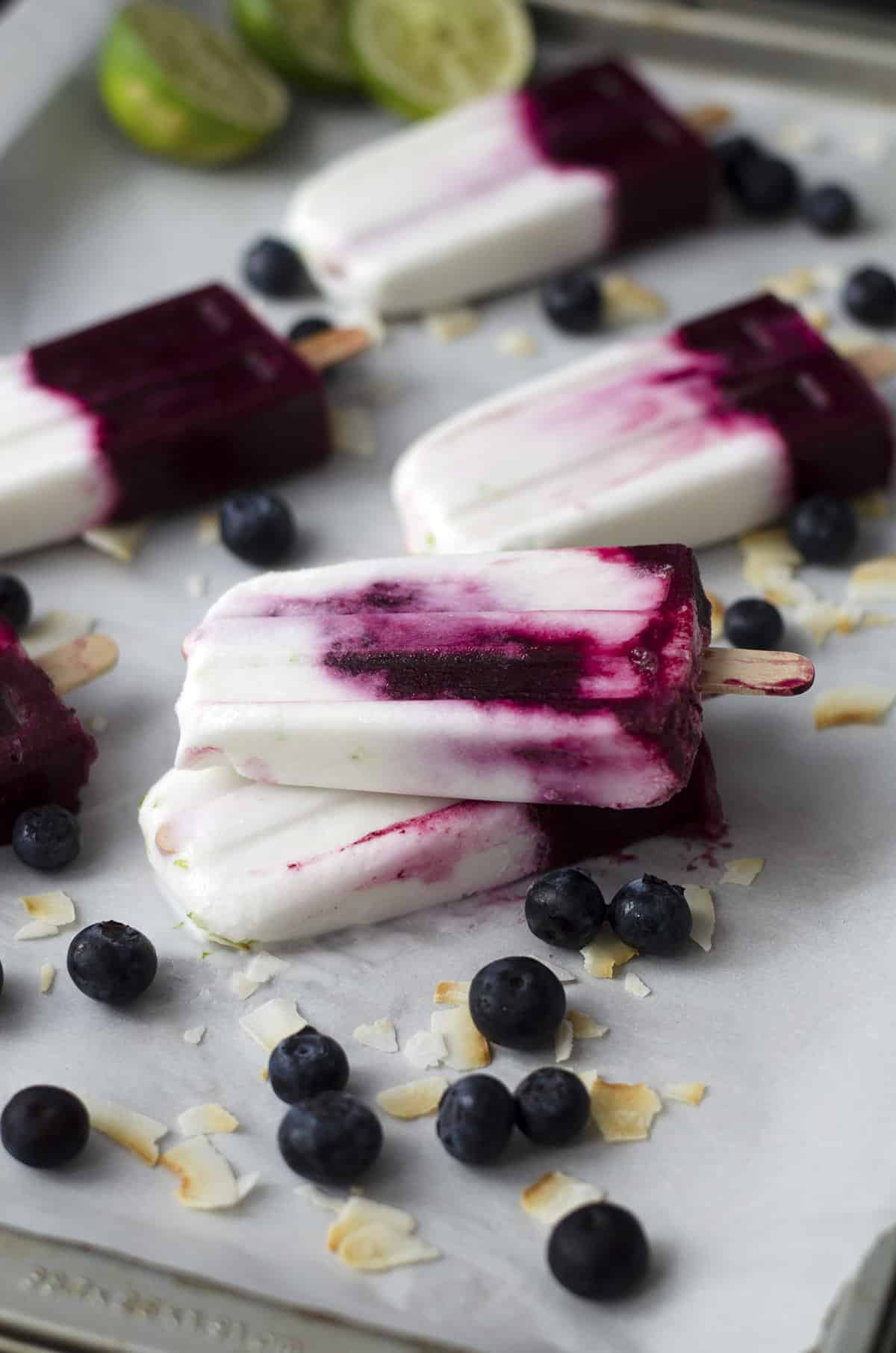 Roasted Blueberry, Coconut And Lime Popsicles! Roasting Intensifies The Sweetness Of The Berries, With Very Little Added Sugar. Layers Of Roasted Blueberries, Coconut And Lime. Vegan &Amp; Gluten-Free | Www.delishknowledge.com