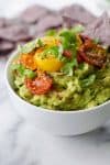 Roasted Tomato Guacamole! The perfect dip for summer or to spread on avocado toast. Vegan & Gluten-Free | www.delishknowledge.com