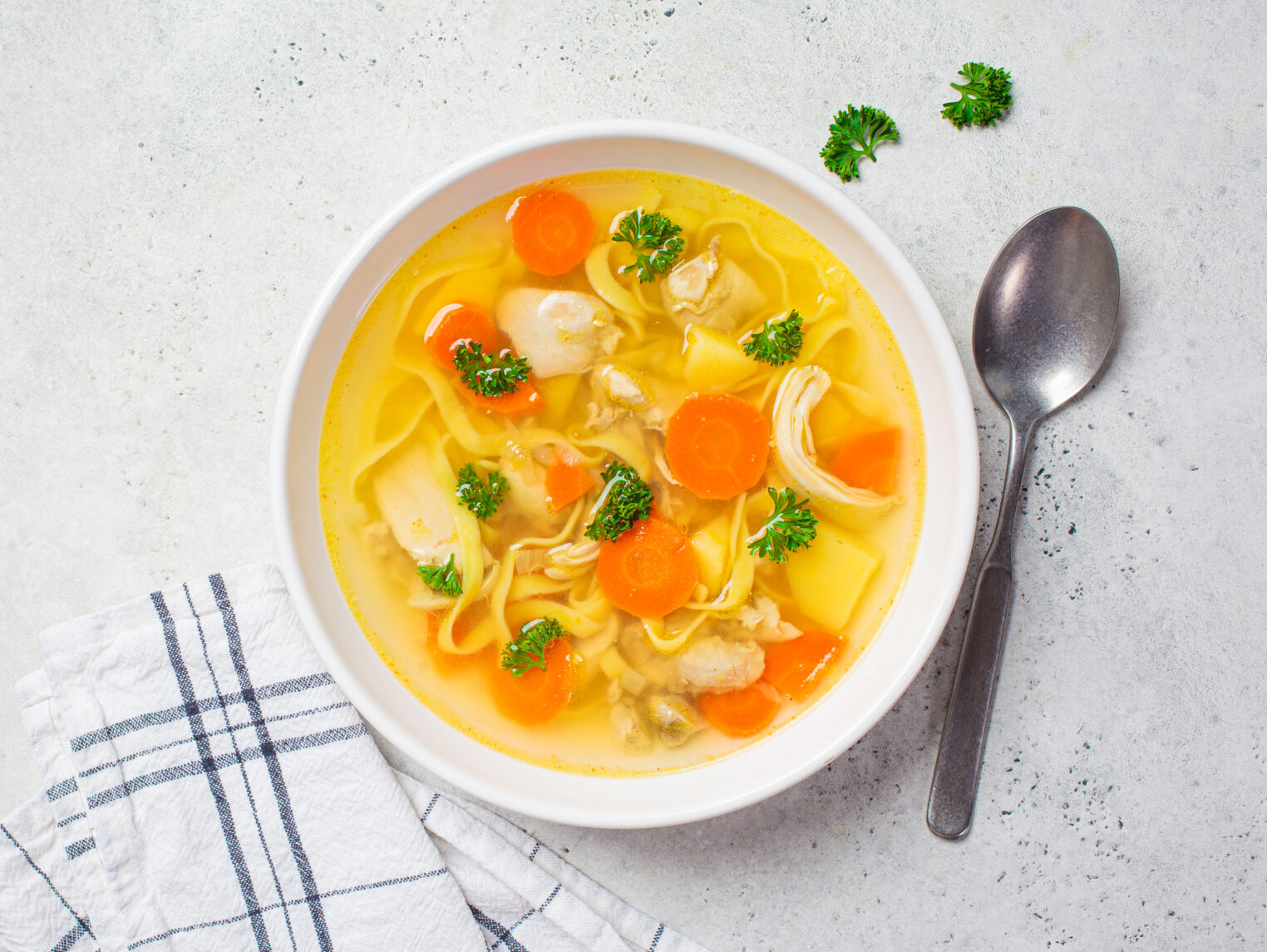 Homemade,Chicken,Soup,With,Noodles,And,Vegetables,In,A,White