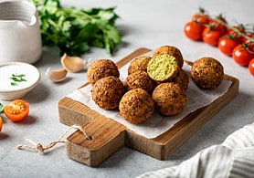 falafel balls on a wooden cutting board, selective focus