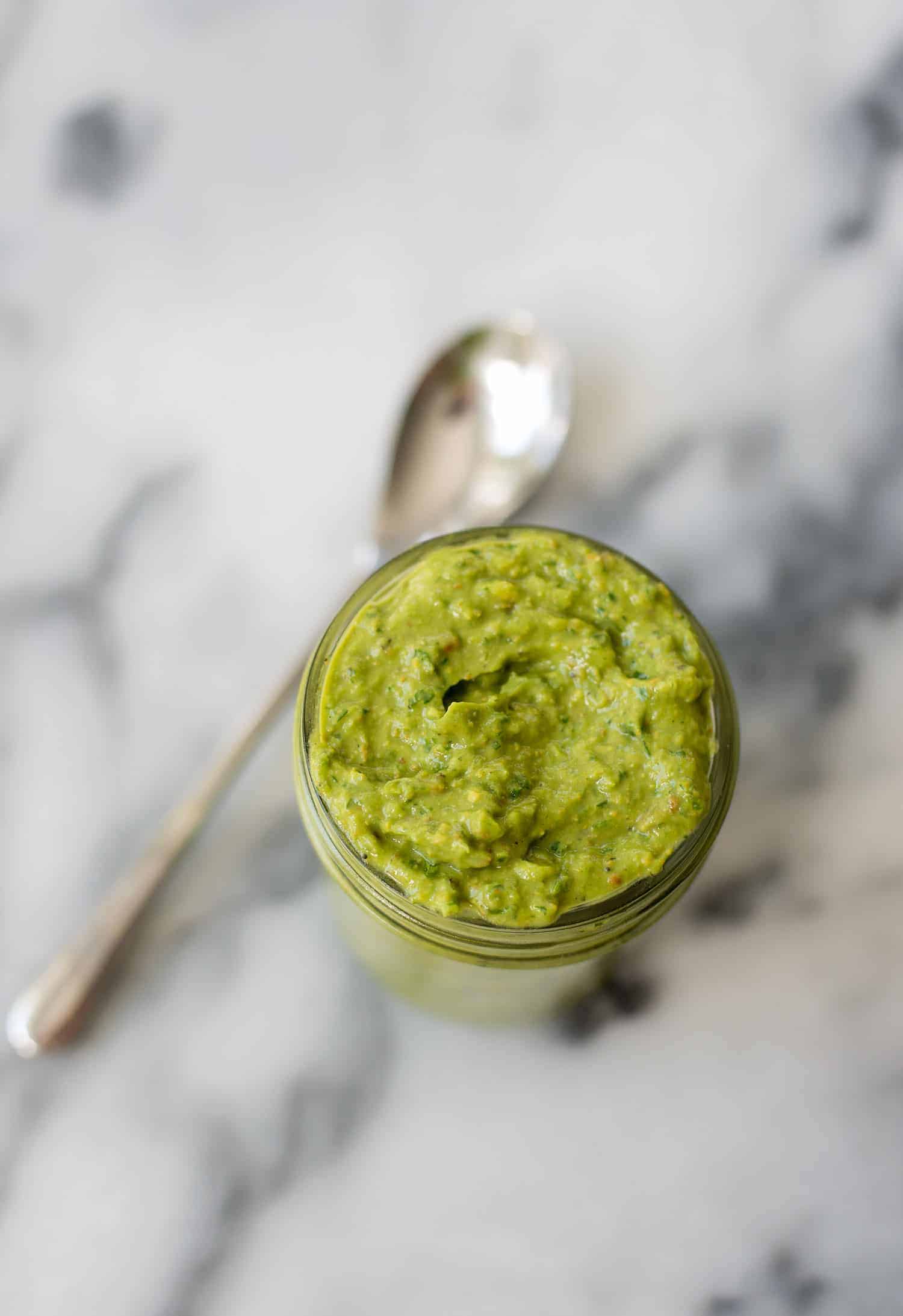 Spicy Green Sauce! Pesto meets guacamole! You are going to love this healthy sauce, perfect for topping on just about everything. Tacos, sandwiches, pasta, ect. Vegan & Gluten-free | www.delishknowledge.com