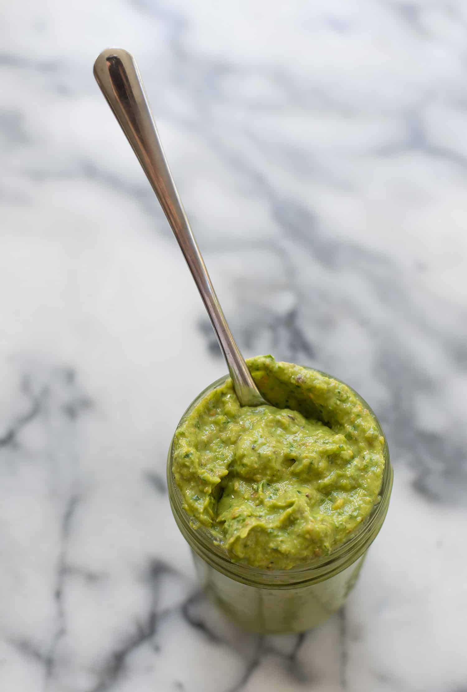 Spicy Green Sauce! Pesto meets guacamole! You are going to love this healthy sauce, perfect for topping on just about everything. Tacos, sandwiches, pasta, ect. Vegan & Gluten-free | www.delishknowledge.com