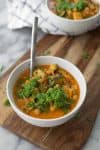 Late Summer Minestrone with Basil Pesto Swirl! A cheaters vegetable minestrone made with Pacific Food's vegan creamy tomato soup and vegetable broth. Filled with fresh vegetables, beans and topped with a fresh basil-oil swirl. Vegan and Gluten-free | www.delishknowledge.com
