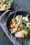 Sweet Potato Tahini Buddha Bowls! You are going to love these healthy, plant-based bowls. Roasted sweet potatoes, spinach, couscous, beans and homemade goddess dressing. Vegan. | www.delishknowledge.com