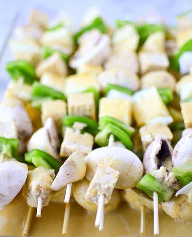 Grilled veggie kebobs with pineapple, mushrooms, peppers and tempeh! Slathered in a sweet and spicy pineapple-serrano sauce! Served with cilantro rice.