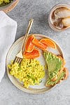 eggy tofu scramble with avocado toast and oranges
