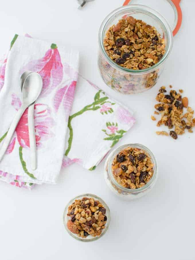 Trail mix granola! Healthy baked granola clusters of almonds, sunflower seeds, and walnuts. Layered in jars with frozen fruit and yogurt for a quick on-the-go breakfast! Vegan or vegetarian; gluten-free
