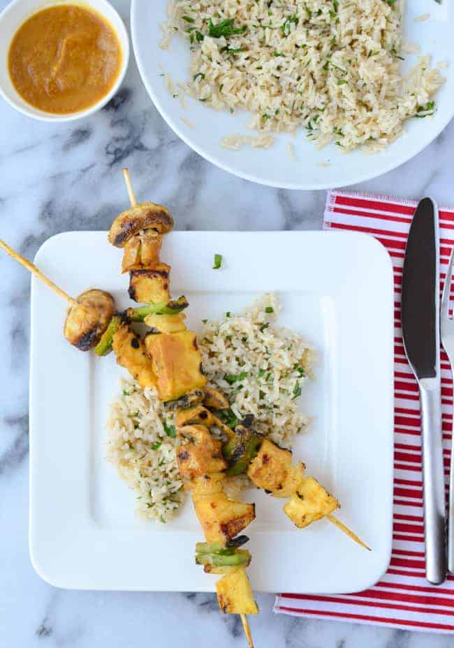 Grilled veggie kebobs with pineapple, mushrooms, peppers and tempeh! Slathered in a sweet and spicy pineapple-serrano sauce! Served with cilantro rice.