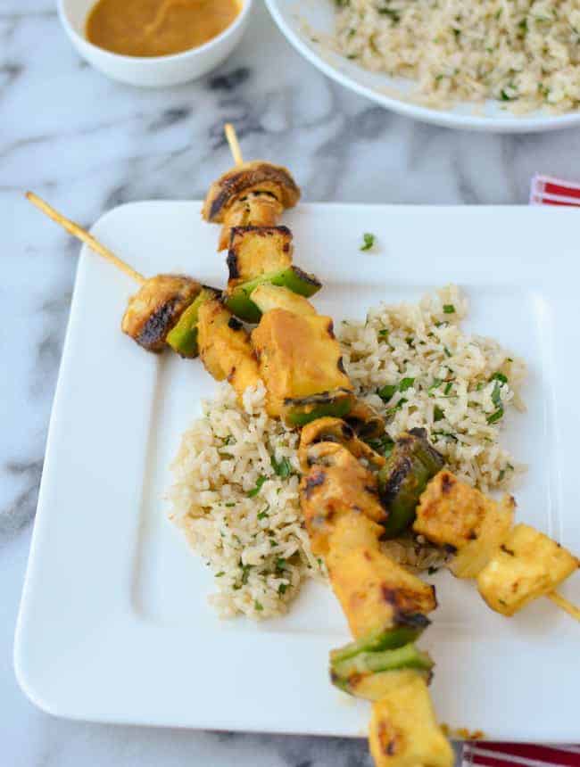 Grilled veggie kebobs with pineapple, mushrooms, peppers and tempeh! Slathered in a sweet and spicy pineapple-serrano sauce! Served with cilantro rice.