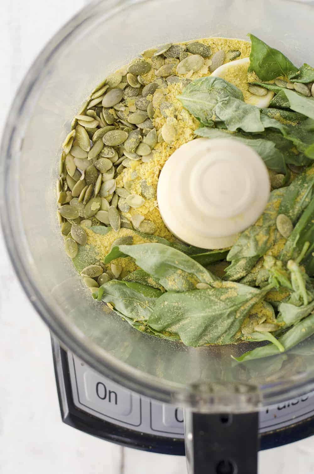 Basil, Nutritional Yeast, And Pumpkin Seeds In Food Processor