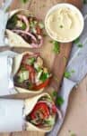 You'd never guess this was vegan! Meaty eggplant gyros stuffed with vegetables, herbs and the best hummus sauce. So good! #vegan #vegetarian | www.delishknowledge.com