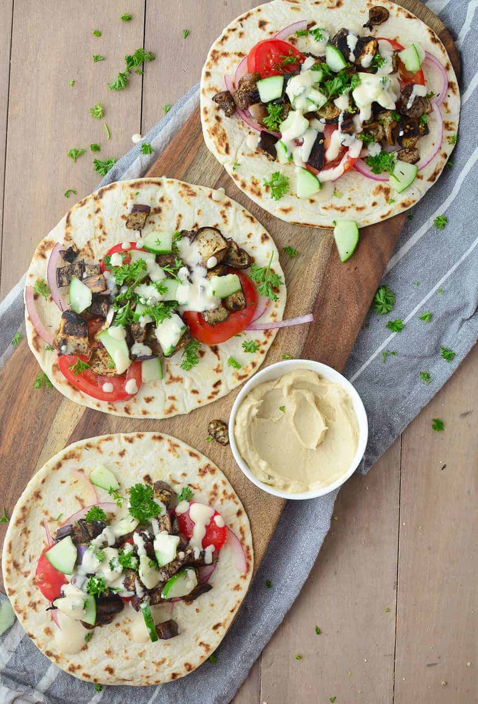 Three Pita Breads Filled With Eggplant And Fresh Vegetables