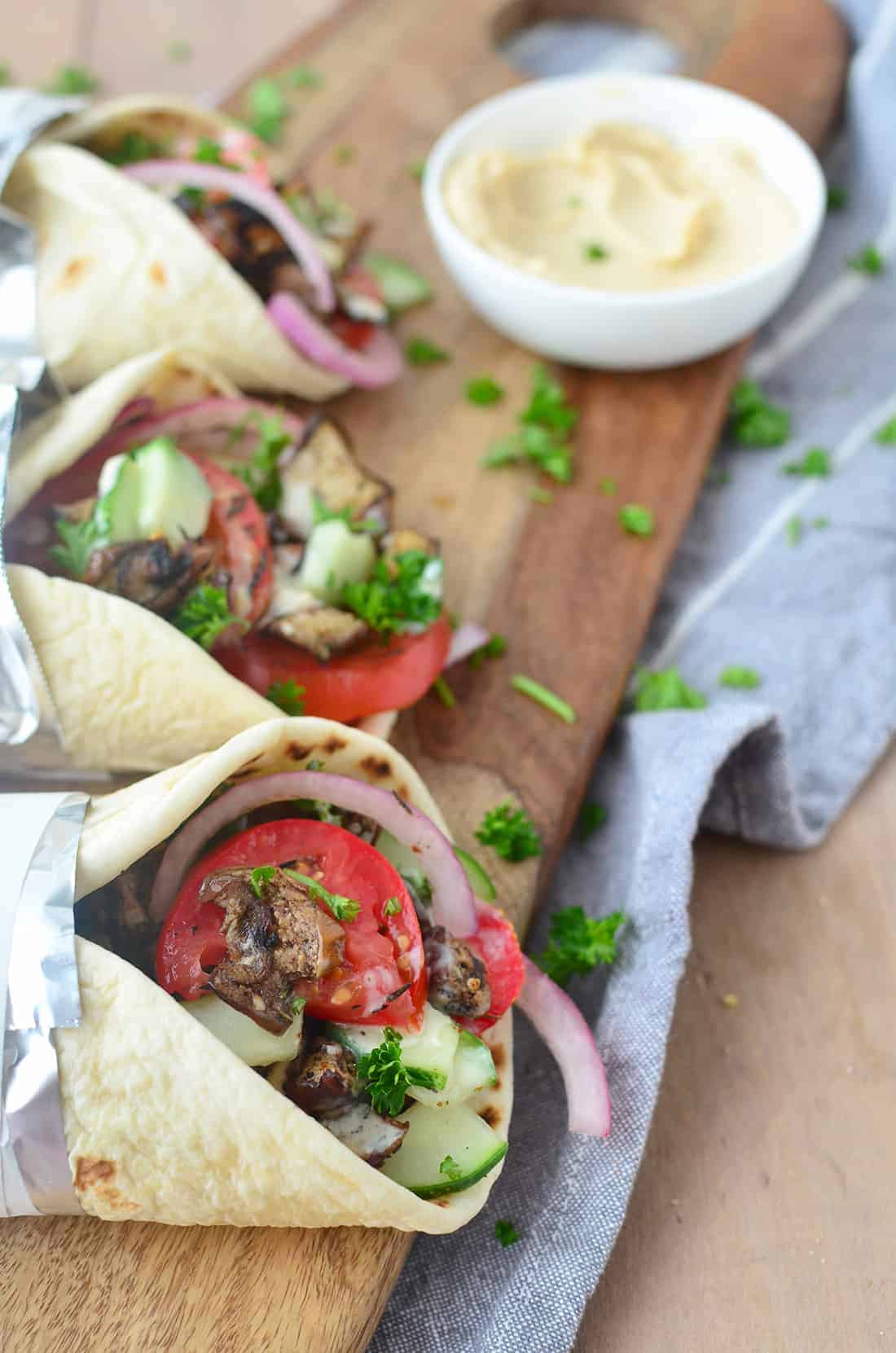 Three Vegan Gyros On Wooden Cutting Board