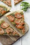 two slices of pesto pizza