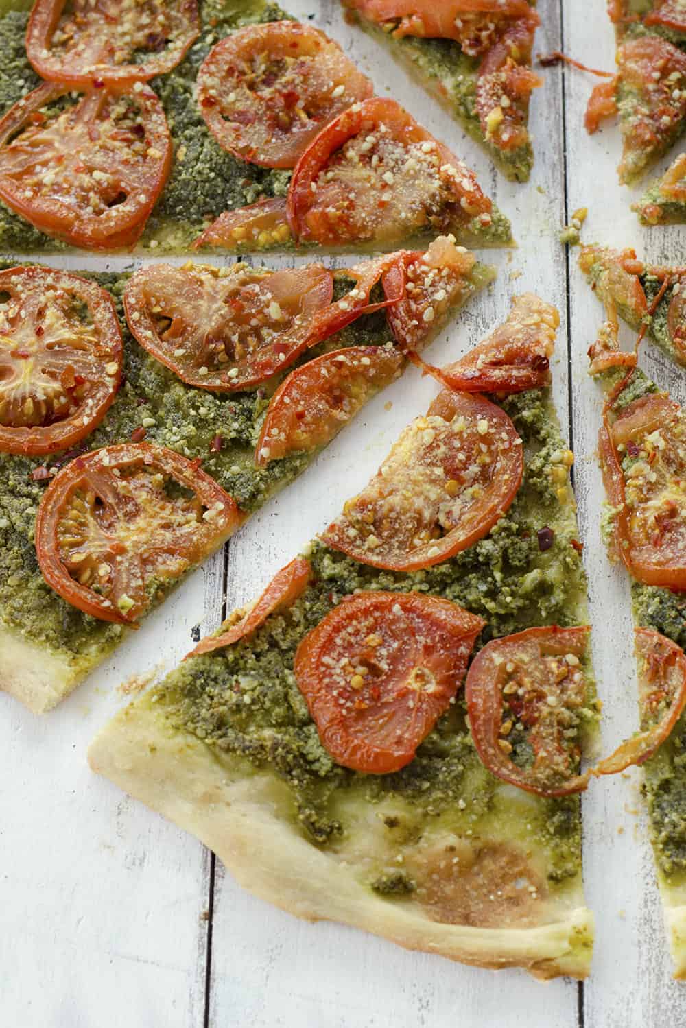 Top View Of Pesto Pizza On White Surface