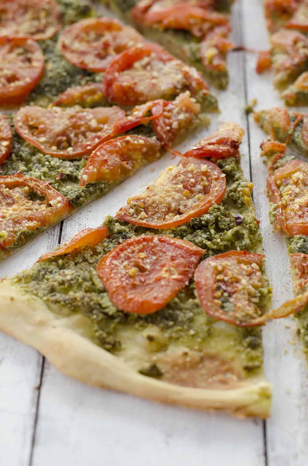 One Slice Of Pesto Pizza With Tomatoes