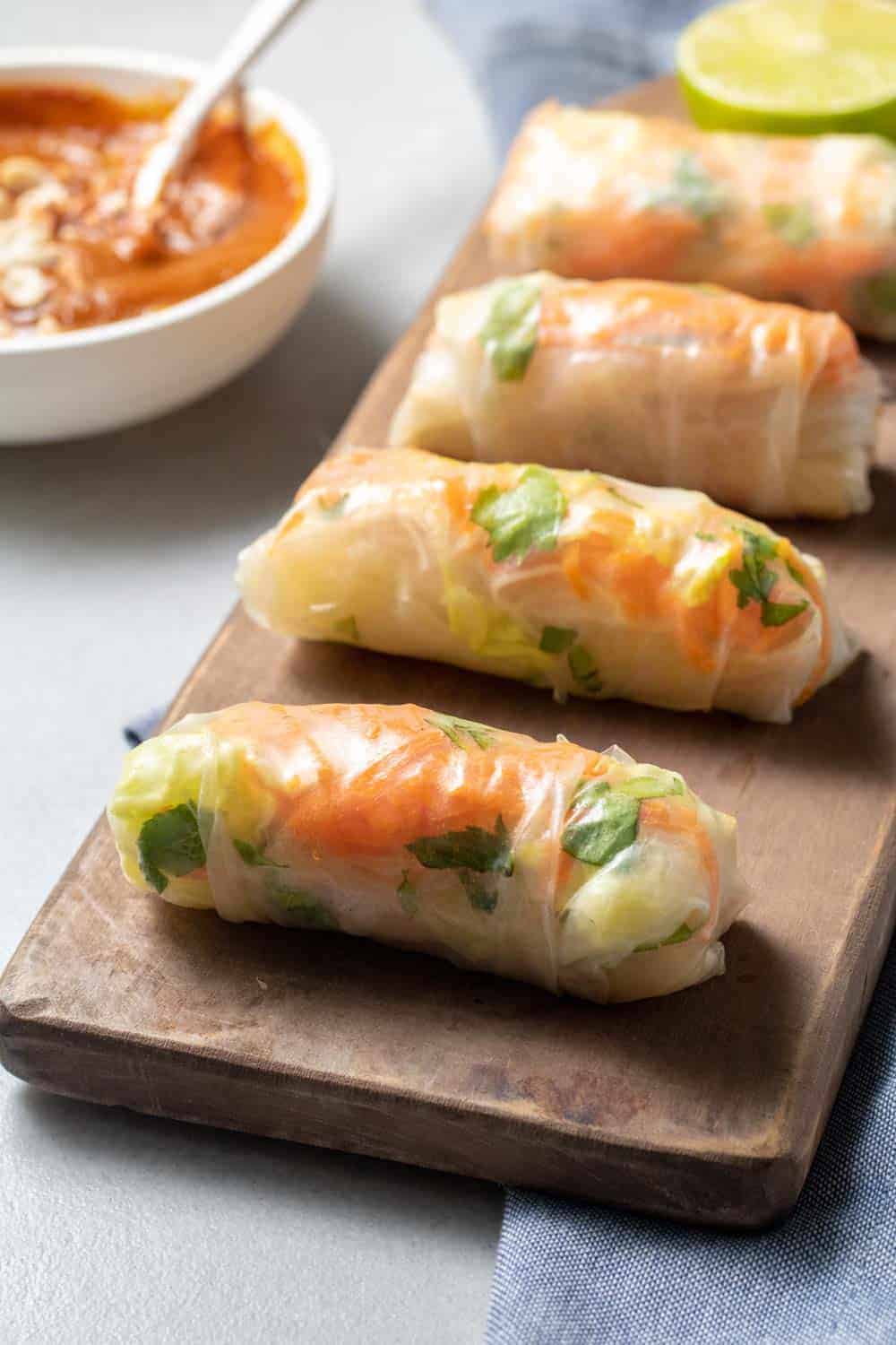 Vietnamese Tofu Spring Rolls With Peanut Sauce On Serving Platter With Bowl Of Sauce In Background